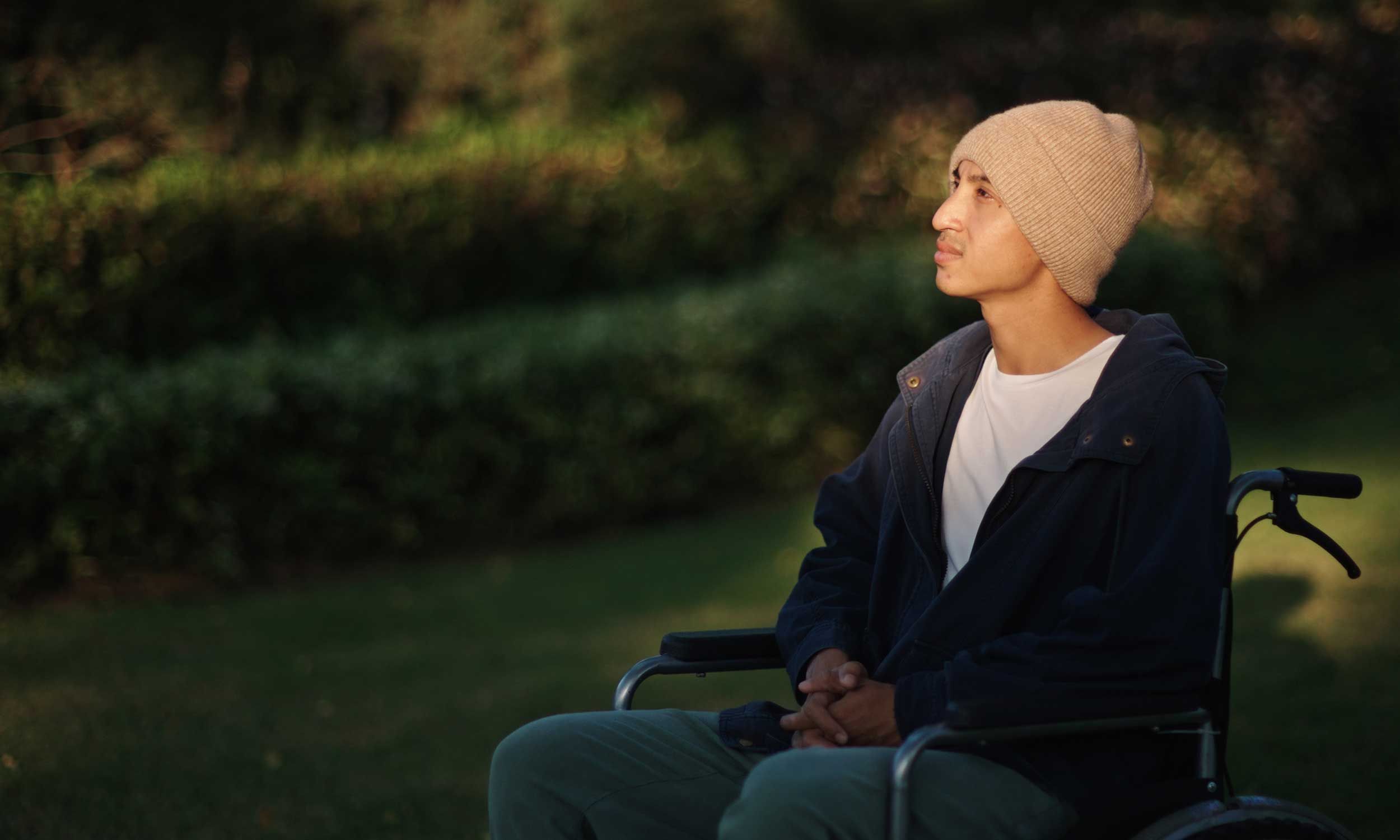 A man with cancer due to smoking sitting in a wheel chair